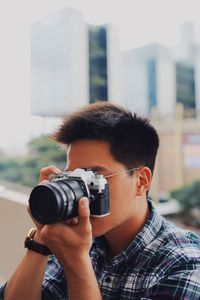 Portrait of man photographing camera