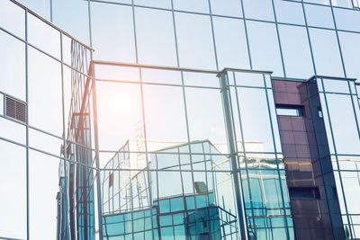 Low angle view of glass building against clear sky