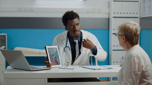 Doctor talking with patient in clinic