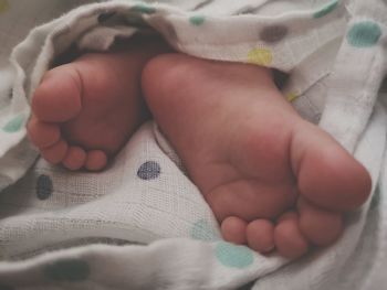 Midsection of baby boy on bed