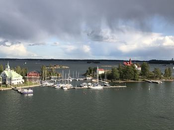 Scenic view of river against sky in city