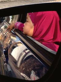 Rear view of woman sitting in train