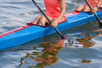 Midsection of woman sitting in boat