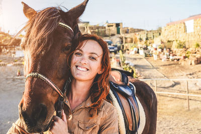 Portrait of smiling woman with horse