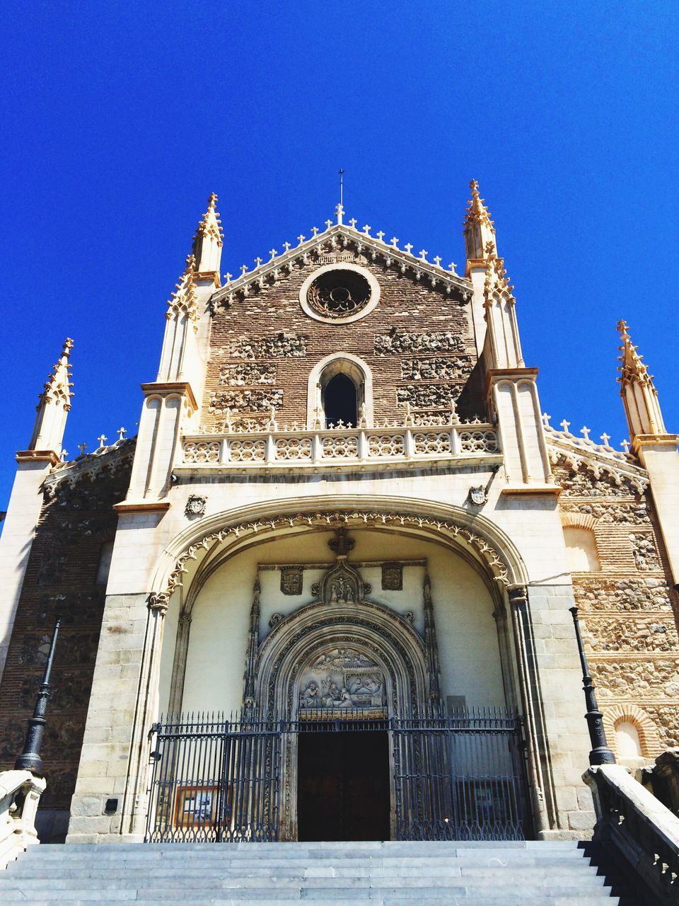 place of worship, religion, architecture, church, building exterior, built structure, spirituality, clear sky, cathedral, blue, low angle view, facade, cross, history, travel destinations, sunlight, famous place, day