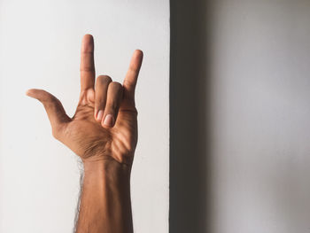 Close-up of hand on wall