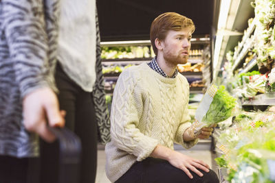 Man shopping lettuce at supermarket