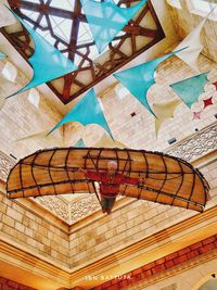 Low angle view of multi colored umbrellas on ceiling