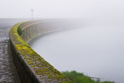 Stone bridge over the lake coveredby fog in sete cidades, sao miguel island, azores