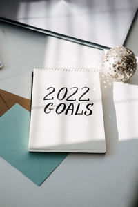 2022 goals, new year resolution. text 2022 goals in open notepad on the table. start new year