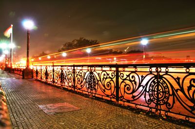 Illuminated bridge against sky at night