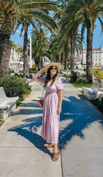 Full length portrait of beautiful young woman wearing stylish summer dress in split, croatia.