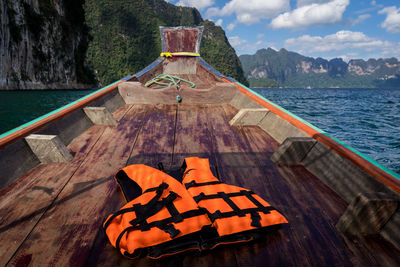 Life jacket with wood prow of a ship going on the sea.