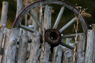 Close-up of rusty wheel on wood