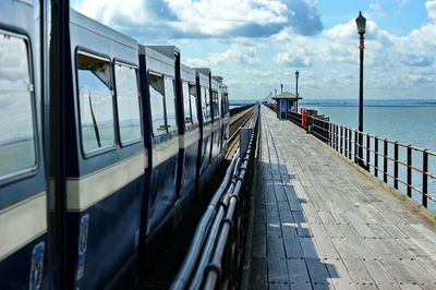 Panoramic view of footpath by sea against sky