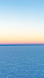 Scenic view of sea against clear sky during sunset