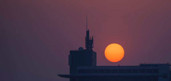 Low angle view of building against sky during sunset