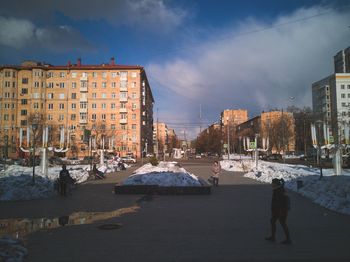 People walking on street in city during winter