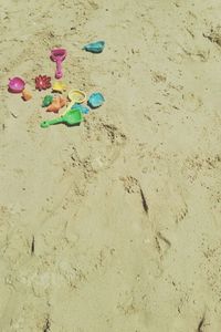 High angle view of toy playing on sand at beach