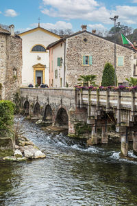 The beautiful colored houses of the hamlet of borghetto sul mincio reflecting on the water