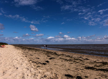 Scenic view of beach against blue sky