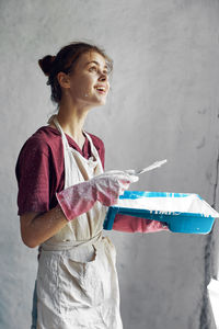 Side view of woman holding book