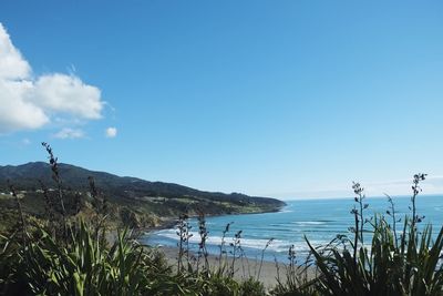 Scenic view of sea against blue sky