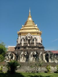 Low angle view of historic building against clear blue sky