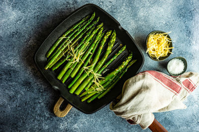 Organic grilled asparagus served for healthy keto lunch on stone background with copy space