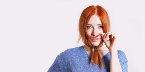 Portrait of young woman against white background