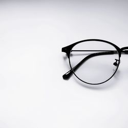 High angle view of eyeglasses against white background