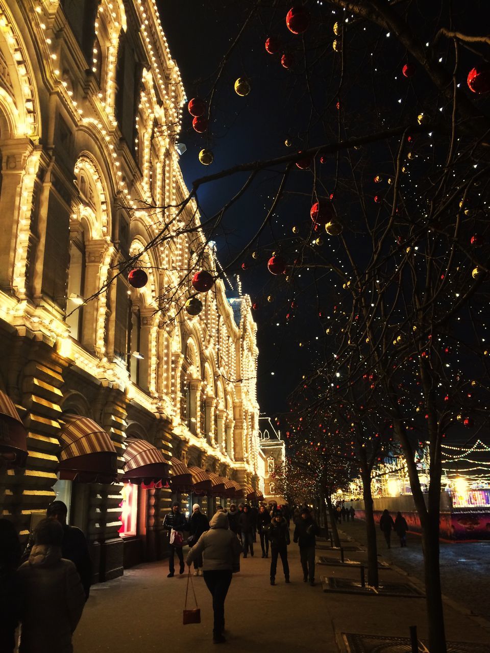 illuminated, architecture, celebration, built structure, building exterior, night, christmas, city, hanging, christmas decoration, outdoors, sky, no people