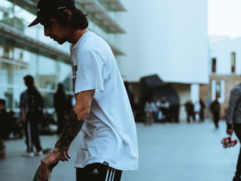 Side view of man walking on street in city