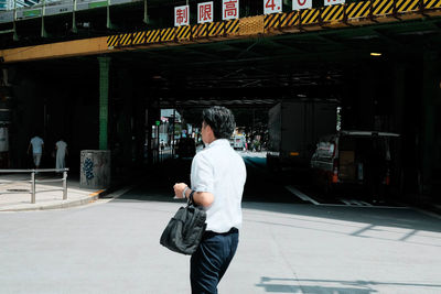 Rear view of man standing in city