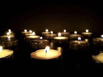 Burning candles on table at home