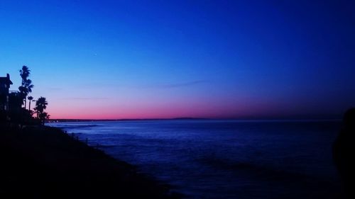 Scenic view of sea against clear sky at sunset