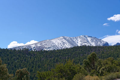 Scenic view of snowcapped mountains against blue sky