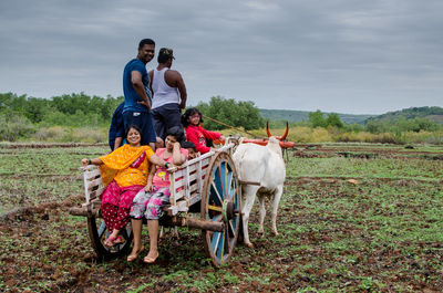 Young couple riding horse cart