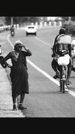 Woman standing on road