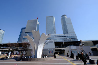 Nagoya station against clear blue sky in city