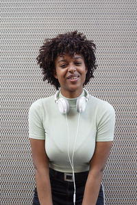 Portrait of a girl with afro hair smiling in the urban background. black girl in casual clothes.