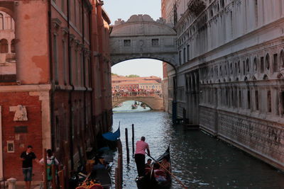 View of people on bridge over canal