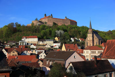 Buildings in town against sky