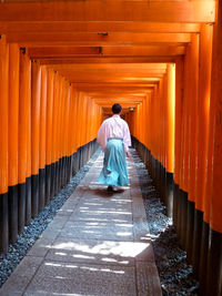 Rear view of man walking in temple