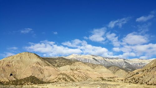 Panoramic view of landscape against blue sky