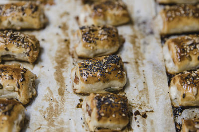 Small buns with sesame on parchment