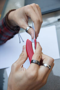 Cropped hands of woman stapling paper