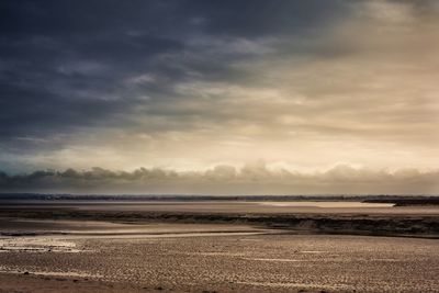 Sandy beach against sky