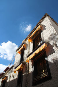 Low angle view of building against cloudy sky