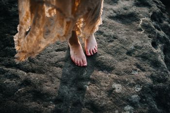 Low section of woman standing on rock